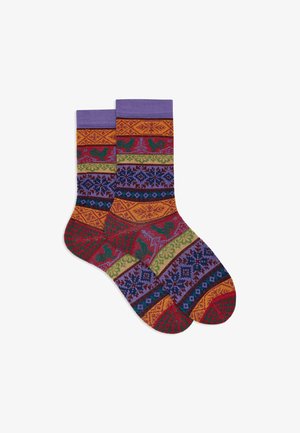 Colorful patterned socks featuring a mix of red, green, purple, and yellow hues with geometric designs, imagery of roosters, and textured knit.