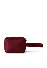 Red textured cosmetic bag with a rectangular shape, zipper closure, and a side strap featuring embossed lettering. Smooth interior lining.