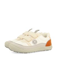 Zapatillas deportivas blancas con correas de Velcro, acentos en gris y beige, parche con logotipo redondo, suela de goma texturizada y detalle en el talón en naranja.