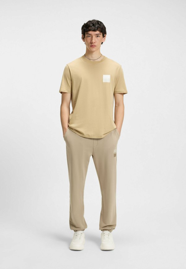 DUSPLITAN - Tracksuit bottoms - beige nine3