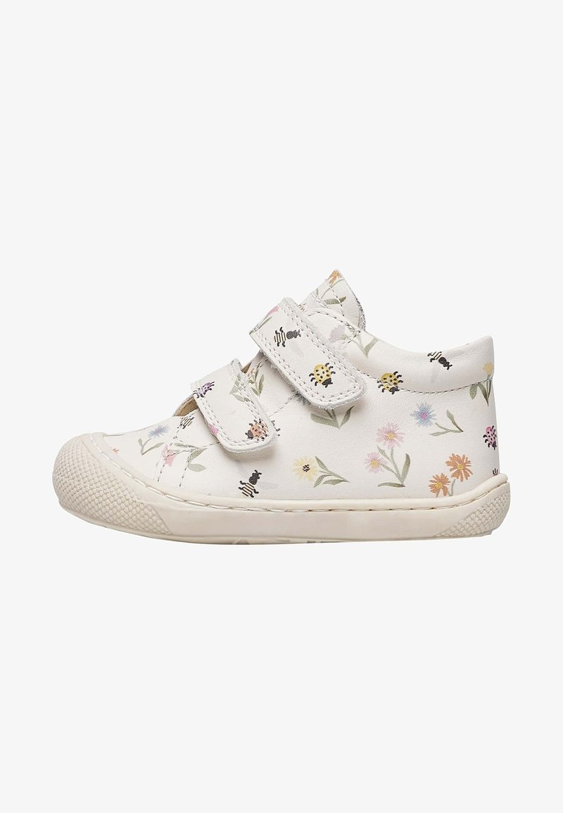 White children's sneaker with floral and bug print, two Velcro straps, and textured rubber sole and toe cap.