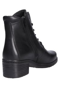 Black ankle boot made of leather with a rounded toe and lace-up front. Features a side zipper and a textured, stacked heel.