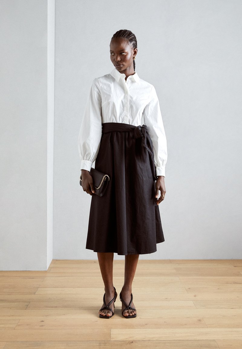velvet black short dress Two-Piece Set: Black Bustier Top & White Pleated Midi Skirt