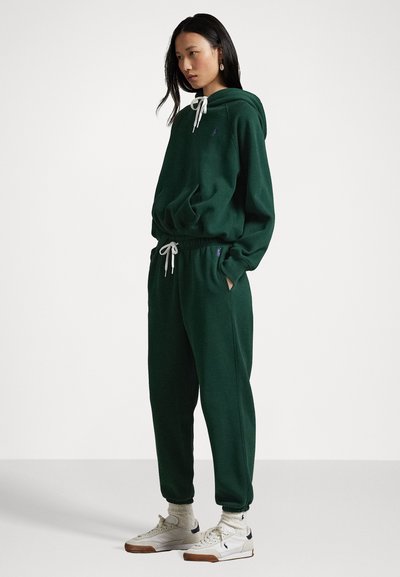 Green cotton hoodie and sweatpants set. Hoodie features a drawstring, kangaroo pocket, and logo. The pants have an elastic waistband and cuffs.