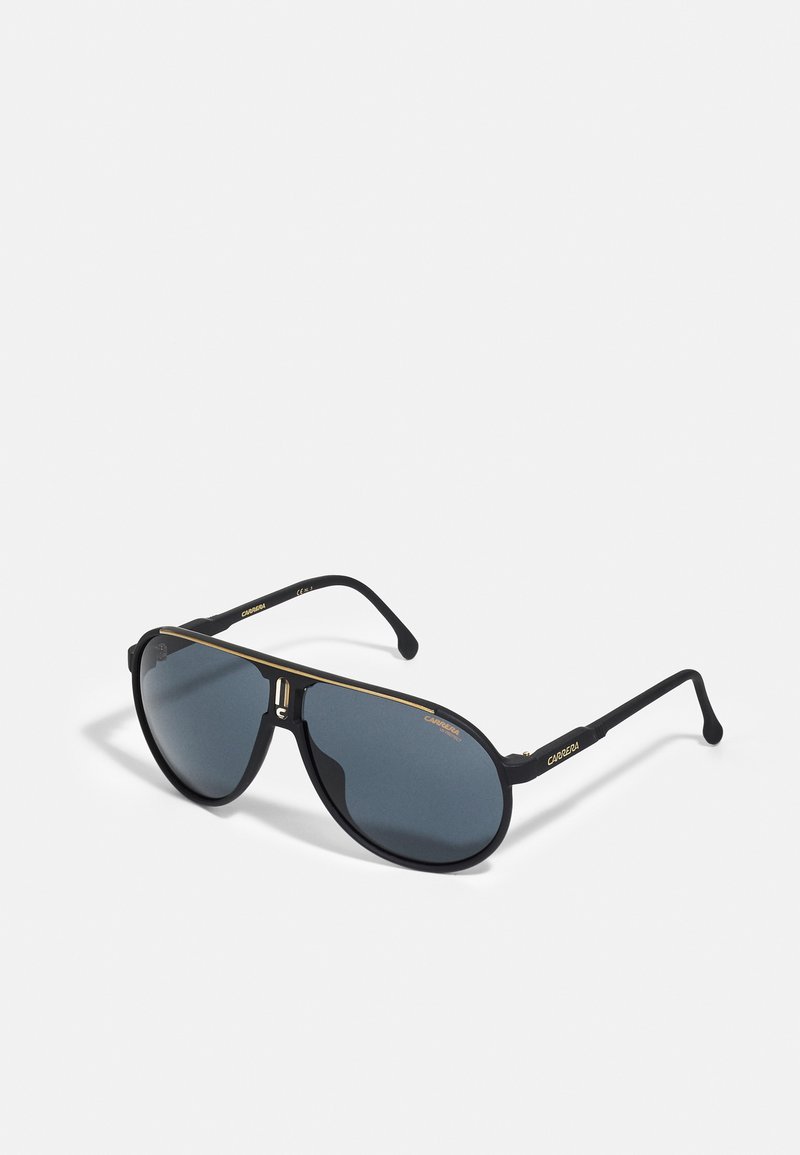 Sorte aviator-solbriller med mørke linser, gulldetaljer og matt finish. Rammen har et særpreget brodesign og slanke stenger.
