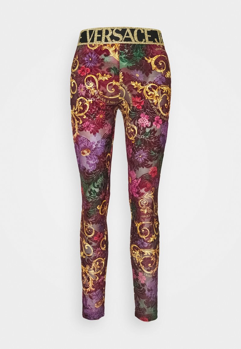 Leggings featuring a multicolored floral and baroque pattern with a gold elastic waistband, made from a sheer, stretchy fabric.