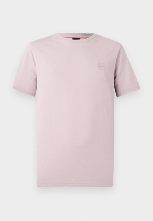 Light pink crew-neck t-shirt made of soft cotton, featuring short sleeves and a small embossed logo patch on the chest.