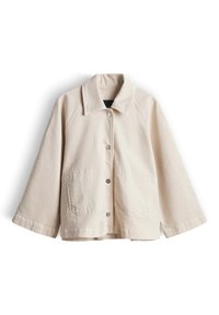 Beige Jacke zum Knöpfen mit weitem Ärmeln, einem Kragen, zwei aufgesetzten Vordertaschen und einer lockeren, kastigen Passform.