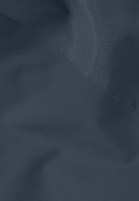 Dark blue fabric with two distinct weaves creating a diagonal seam and subtle texture variations.