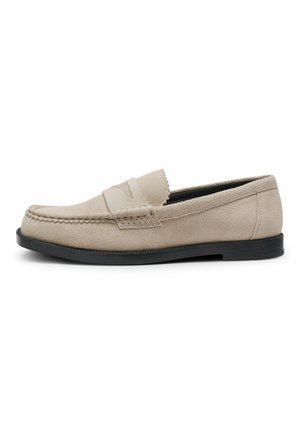 Beige suede loafer shoe with black sole, moc toe stitching, and penny strap detail, shown from the outer side on a white background.
