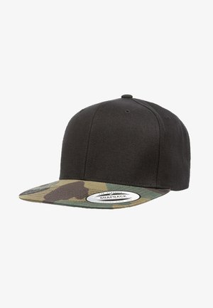 Black snapback cap with a solid fabric body and a camo-patterned brim. Features a white label on the front. Durable material.