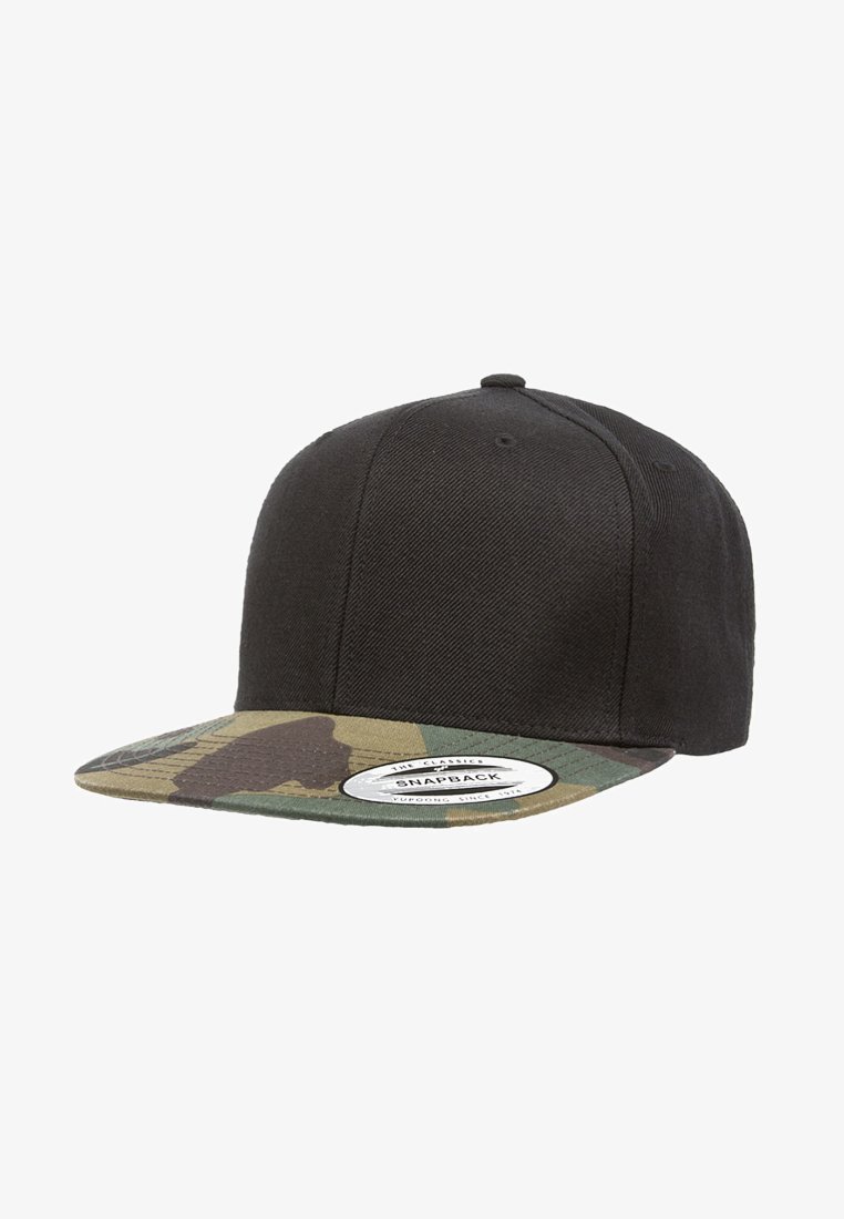 Black snapback cap with a solid fabric body and a camo-patterned brim. Features a white label on the front. Durable material.