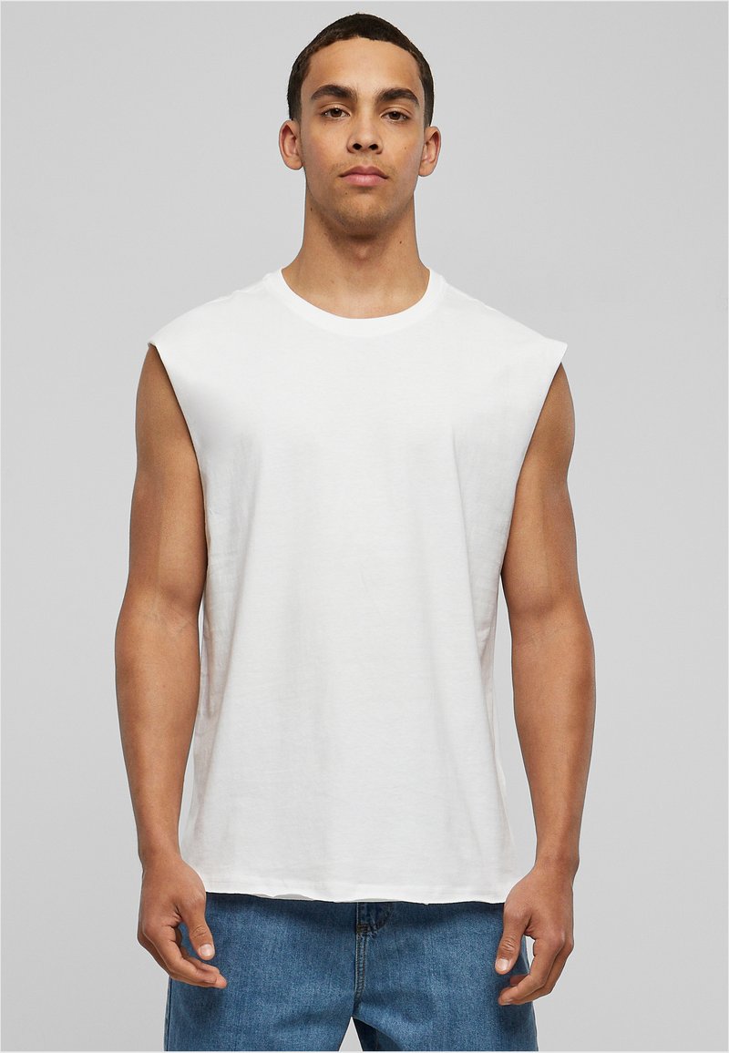 T-shirt blanche sans manches à coupe décontractée, en coton doux. Présente un col rond et un minimalisme dans les détails de couture.
