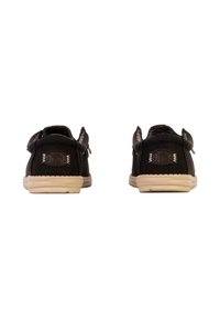 Scarpe in pelle nere con finitura liscia, suole in gomma beige e una fascia autobloccante. Presentano dettagli firmati sul tallone.