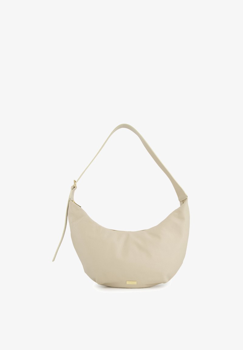 Cream-colored leather shoulder bag with a curved, soft shape, featuring a thin strap and a gold hardware accent at the base.