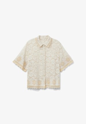 Kortærmet cremefarvet blondebluse med blomsterprint, knapper foran, bølgede kanter og dekorative broderede bånd på ærmer og kant.