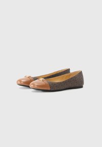 Brown patterned flats with a tan leather cap toe, gold hardware accents, and a smooth interior lining. Rubber sole for grip.