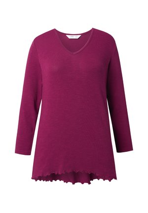 Maglia a maniche lunghe in magenta intenso, con scollatura a V e orlo curvo con bordo ondulato. Realizzata in morbido tessuto testurizzato.