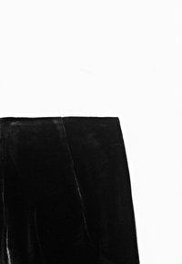 Black velvet skirt with a smooth texture, knee-length design, and a simple, straight silhouette. No visible embellishments or patterns.
