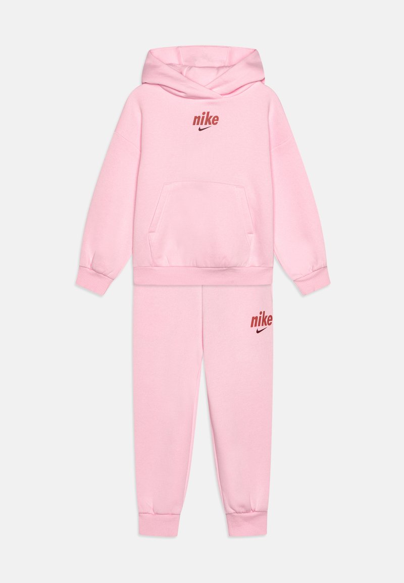 Pink Nike hoodie and sweatpants set, featuring a kangaroo pocket, ribbed cuffs, and red logo accents on both the top and bottom.