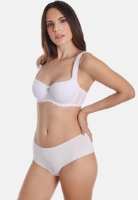 White lace bra with a smooth finish and wide straps, featuring a small decorative button at the center. Paired with plain white bikini bottoms.