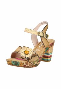 Sandale beige à bout ouvert avec bride à la cheville, talon bloc, motifs floraux et une grande fleur décorative sur la bride avant.