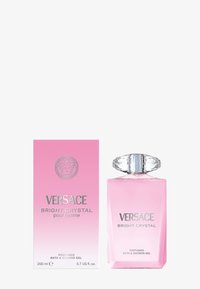 Versace Bright Crystal, 200 ml, presenta una bottiglia di vetro trasparente con un tappo a taglio diamante, liquido rosa e una confezione sfumata rosa con dettagli argentati.