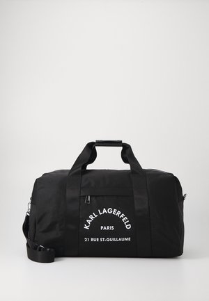 Black duffel bag with dual handles and detachable shoulder strap. Features white text logo on the front and a smooth, durable fabric texture.
