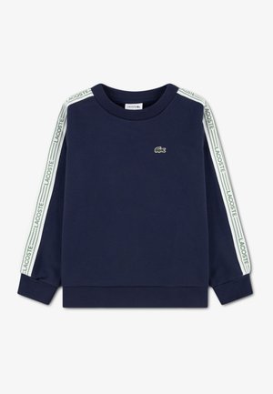 Sweat-shirt bleu marine avec encolure ronde, poignets côtelés et logo Lacoste vert sur les manches. Présente un petit logo crocodile brodé.