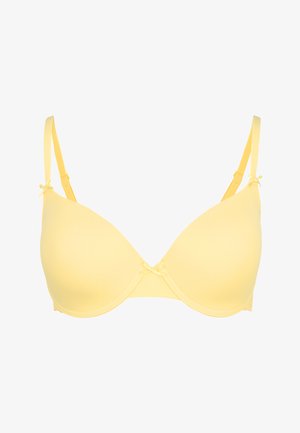 Gelb gepolsterter BH aus glattem Material, mit verstellbaren Trägern und dekorativen Schleifenakzenten in der Mitte und an den Trägerverbindungen.