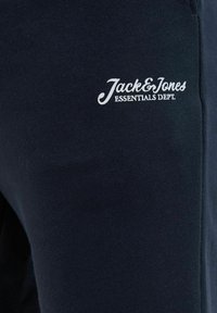 Marine sweatshirt med struktureret stof, en tætsiddende pasform og et hvidt broderet "Jack & Jones Essentials Dept." logo på fronten.