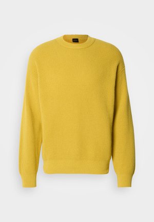 Κίτρινο πουλόβερ με υφή βαφλα, στρογγυλή λαιμόκοψη και ριμπ μανσέτες. Απαλή υφή, κανονική εφαρμογή και μονόχρωμο χωρίς σχέδια.
