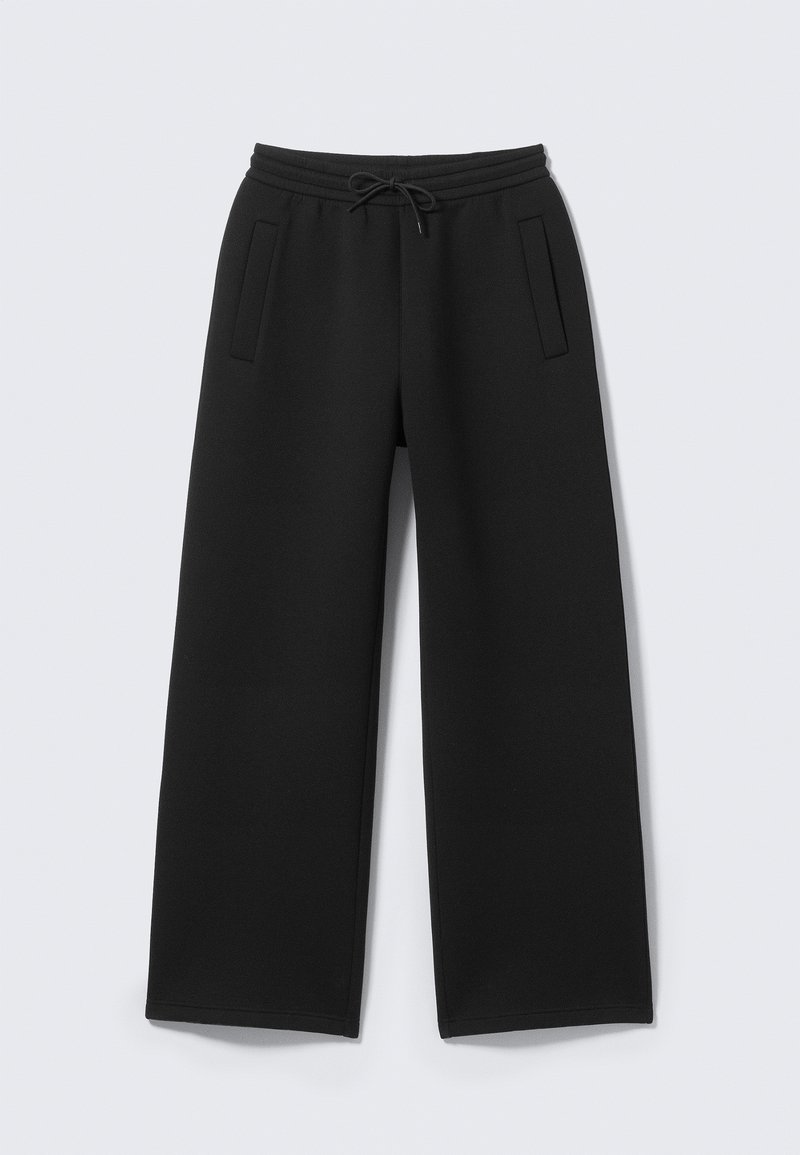 Mustad püksid laiade sääreosadega, kummipaelaga talje ja kahe küljetaskuga. Valmistatud pehmest, tekstureeritud kangast.