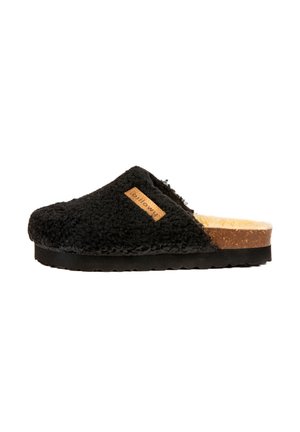 Chausson noir texturé à enfiler avec une tige en fausse fourrure, semelle en liège et étiquette en cuir tan. Présente un bout arrondi et un design bas.