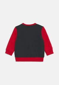 Black and red sweatshirt with long sleeves. Features a solid color design with ribbed cuffs and neckline. Soft cotton fabric.