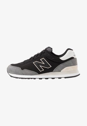 Czarno-szary but sportowy New Balance z białym akcentem na pięcie, cholewką z siateczki i zamszu oraz fakturowaną gumową podeszwą, widok z boku.