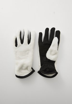 Black and white gloves featuring a soft, fuzzy exterior, textured grip on fingers, elastic wrist, and logo embroidery on the white side.
