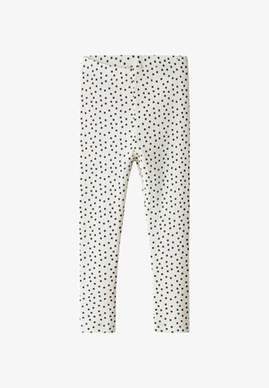 Black polka dot leggings with a ribbed texture, featuring an elastic waistband. The base color is light cream.
