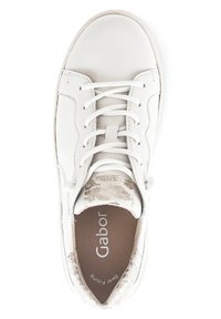 White sneaker with smooth leather upper, round toe, flat laces, and floral pattern on the tongue. Interior features padded lining and branding.