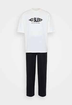 White cotton t-shirt with "NO SLEEP CLUB" printed in black, paired with black fabric pants. Loose fit, short sleeves, and simple design.
