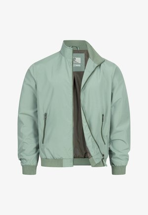 Jasnozielona kurtka bomber z prążkowanymi mankietami i dołem, częściowo rozpiętym zamkiem z przodu oraz zapinanymi na zamek bocznymi kieszeniami.