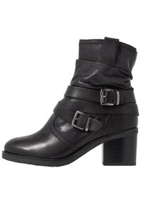 Black leather ankle boot with a slouched design, featuring two adjustable metal buckles and a chunky heel. Smooth texture and rounded toe.