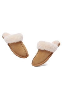 Suede slip-on slippers in tan with a cream faux fur cuff. Soft texture, rounded toe, and flat rubber sole. Features stitched detailing.