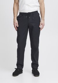 Dark navy, lightweight pants with an elastic waistband, drawstring, and a relaxed fit. Pairing with black casual shoes.