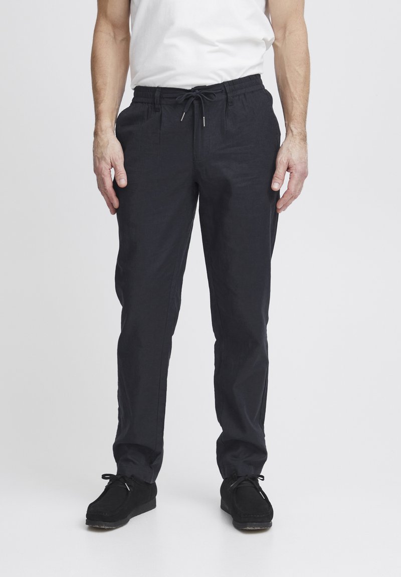 Dark navy, lightweight pants with an elastic waistband, drawstring, and a relaxed fit. Pairing with black casual shoes.