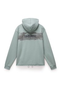 Sweat à capuche vert clair à manches longues avec un motif sombre et un texte imprimés sur le haut du dos.