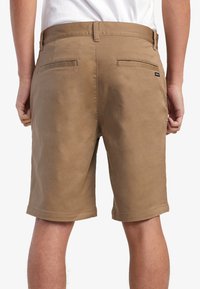 Brune bomuldsshorts med en glat tekstur, der har en lige pasform, baglommer og et logo mærke nær taljen.