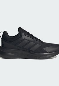 Chaussure de sport noire avec un dessus en maille, des accents texturés et une semelle épaisse dotée de rainures diagonales pour l'adhérence et le soutien.