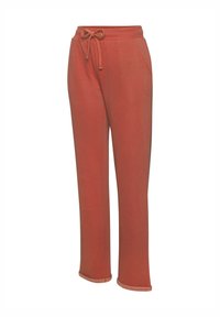 Pantalones de chándal color óxido hechos de tela suave, con cintura ajustable mediante cordón, dos bolsillos laterales y piernas ligeramente acampanadas con dobladillos ajustados.