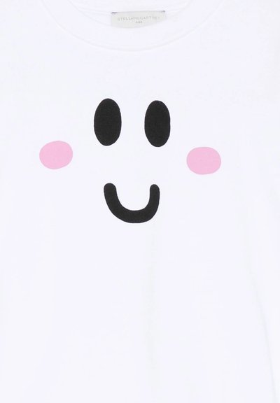 Tissu blanc avec un design de visage souriant comportant deux yeux ovales noirs, une bouche courbée noire et deux joues circulaires roses.